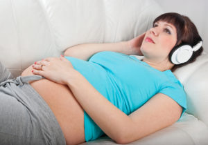 Pregnant woman listening to guided imagery